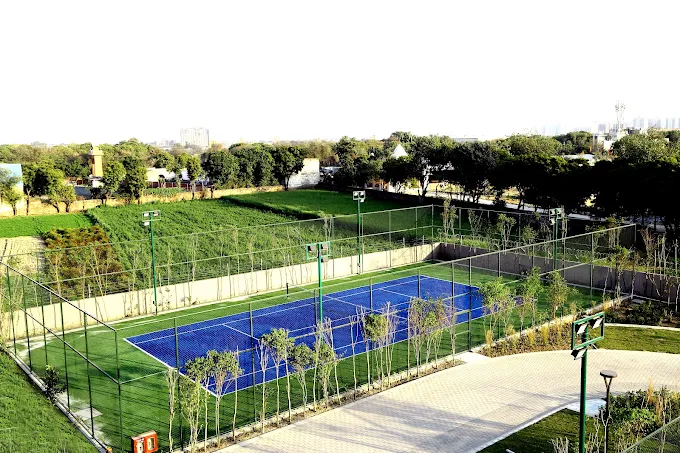 Tennis court tucked into the central green belt at La Vida